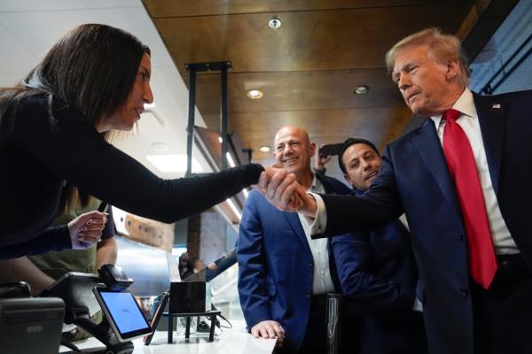 Do<em></em>nald Trump greets people as he visits The Great Commoner, Friday, Nov. 1, 2024, in Dearborn, Mich.
