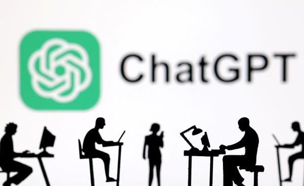 Figurines with computers and smartpho<em></em>nes are seen in front of ChatGPT logo
