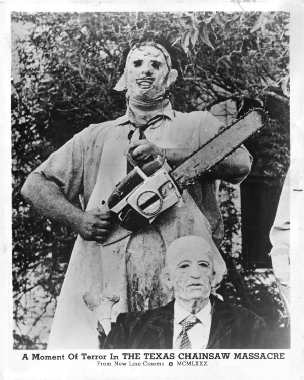 Gunner Hansen holding a chainsaw next to an old man