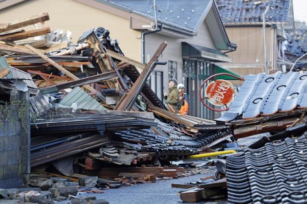 Debris of destroyed houses are pictured in Suzi, Ishikawa prefecture as more than 200 people remain missing.