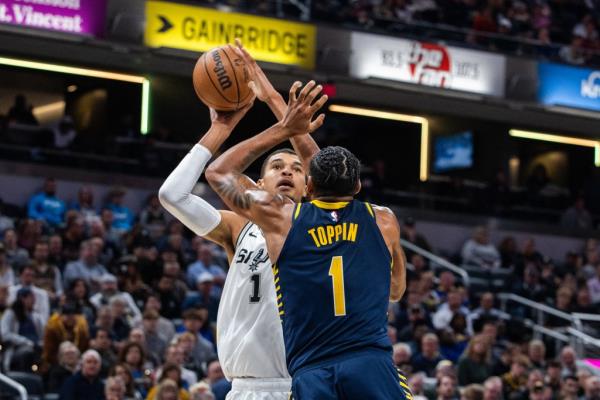 Spurs center Victor Wembanyama (1) shoots the ball while Indiana Pacers forward Obi Toppin (1) defends 