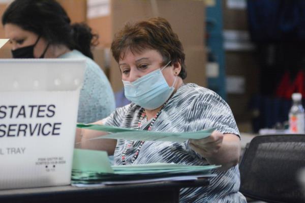 Election bureau staff, Deb McDonald, opening provisio<em></em>nal ballots in Schuylkill County Election Bureau, Pottsville, Pa, with both Democrat and Republican poll watchers present.