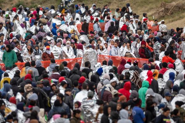 A group of immigrants waiting to be processed at a U.S. Border Patrol center after they crossed the border from Mexico on December 20, 2023.