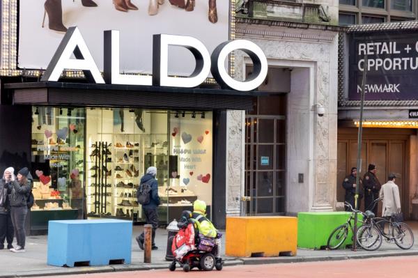 The Aldo store in Times Square is a frequent target of the migrants that hang out outside a shelter next door, a manager said.