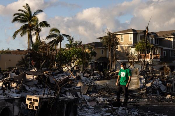 A Mercy Worldwide volunteer makes damage assessment of charred apartment complex in the aftermath of a wildfire in Lahaina, western Maui, Hawaii on August 12, 2023. 
