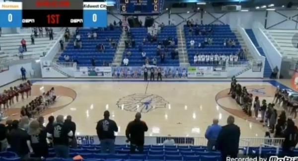 A screengrab of the livestream, showing the Norman players kneeling.
