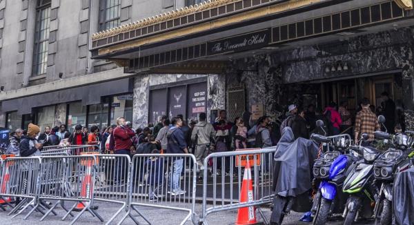 Asylum seekers line up in front of the historic Roosevelt Hotel, co<em></em>nverted into a city-run shelter for newly arrived migrant families in New York City, United States on September 27, 2023. 
