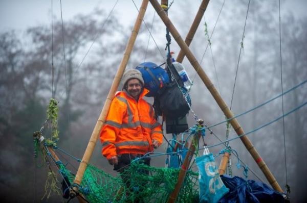 Mandatory Credit: Photo by Maureen McLean/REX/Shutterstock (11290984b) Veteran eco activist Dan Hooper known as Swampy is currently locked o<em></em>nto a huge bamboo structure in the River Colne in Denham HS2 bridge building protest, Denham, UK - 07 Dec 2020 Veteran eco activist Dan Hooper known as Swampy is currently locked o<em></em>nto a huge bamboo structure in the River Colne in Denham. Activists put the 'beacon of truth' in place early this morning. HS2 have already felled many mature trees in Denham Country Park ahead of the bridge construction. Anti HS2 Rebellion activists at the Denham Ford Wildlife Protection Camp are are trying to stop the bridge from going across the River Colne today and further woodland destruction by HS2. The High Speed Rail HS2 from Lo<em></em>ndon to Birmingham puts 108 ancient woodlands, 33 SSSIs and 693 wildlife sites at risk