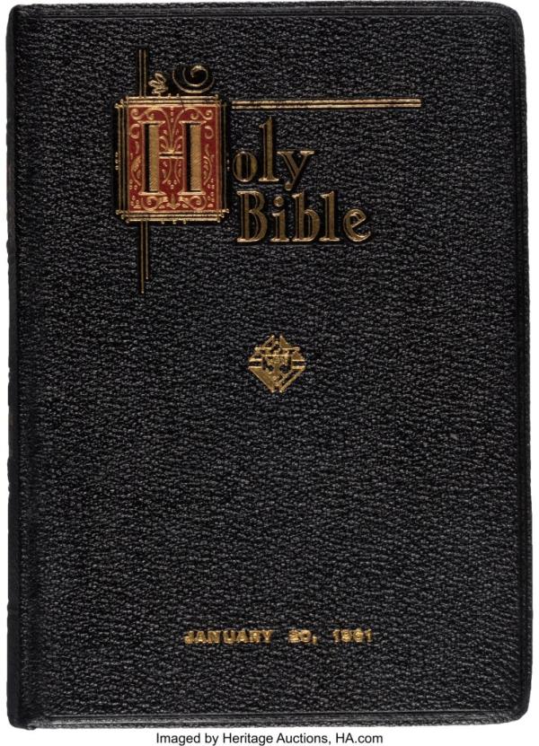 the bible, which has a black cover and gold writing