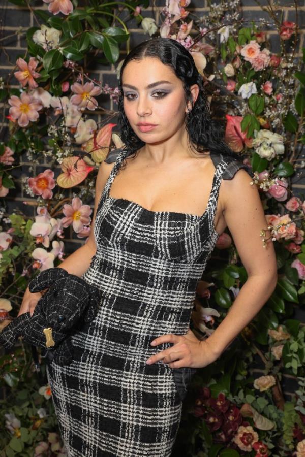 Charli XCX posing in a dress at the Netflix 2024 BAFTA Awards after-party in Chiltern Firehouse, London, England.