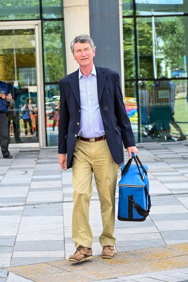 Sir Timothy leaves the hospital after visiting Princess Anne.