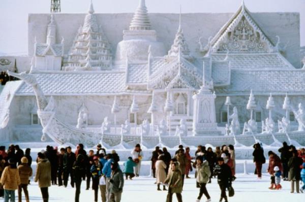 Tourist in front of a snow sculpture, Bangkok's Royal Palace, Snow Festival, Sapporo, Japan
