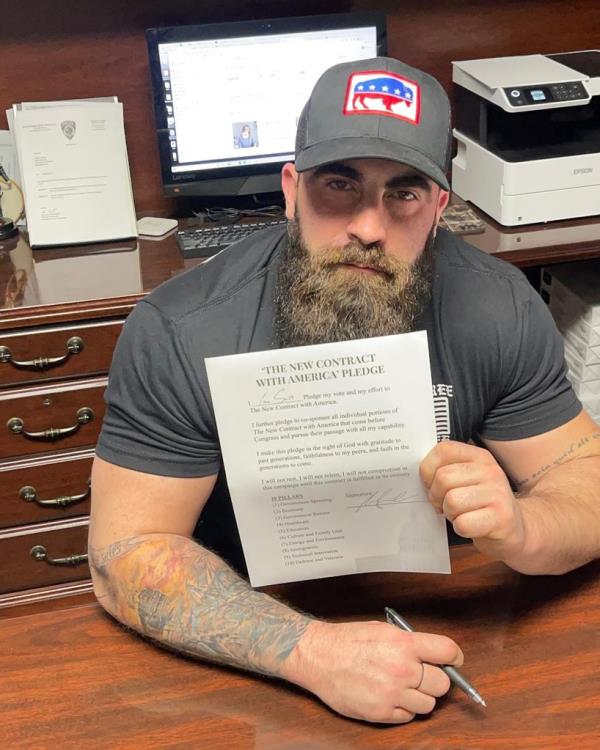 Smith holding a piece of paper. 