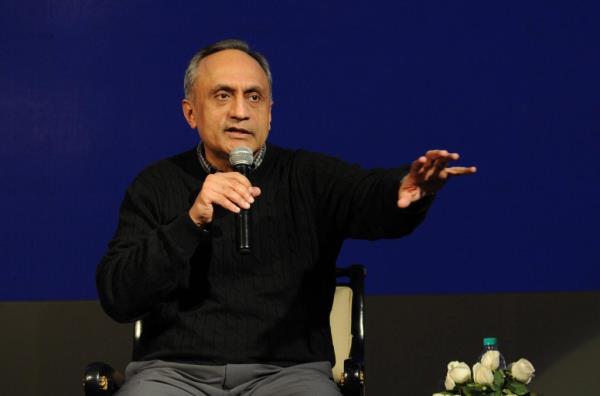 Manoj Bhargava speaking at a conference.