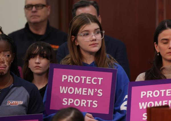 Avery Graziosi, 14, and a group of people holding signs at a press co<em></em>nference with Nassau County Executive Bruce Blakeman