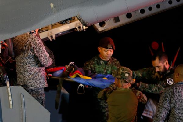 Military perso<em></em>nnel unload from a plane one of four Indigenous brothers who were missing after a deadly plane crash at the military air ba<em></em>se in Bogota, Colombia, Saturday, June 10, 2023.