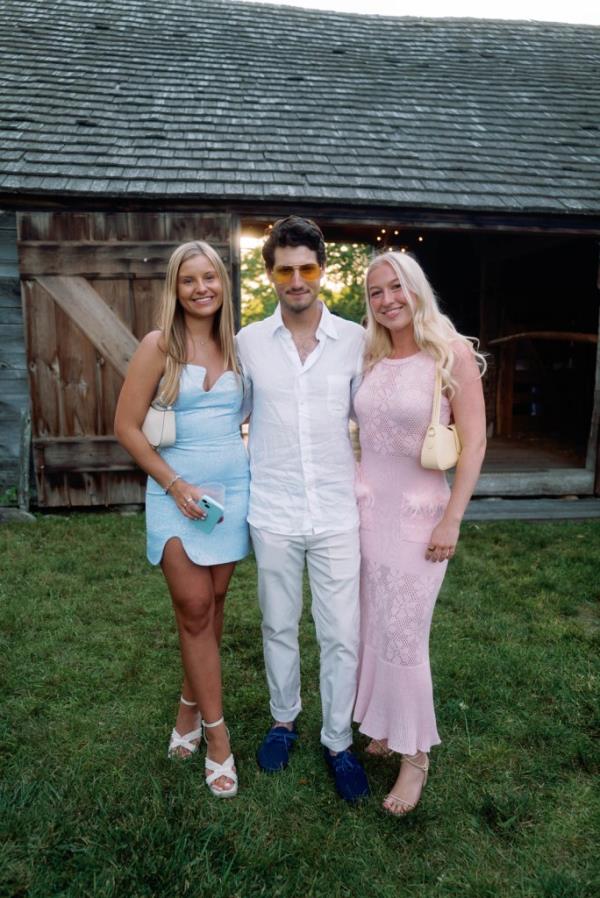 Man standing between two women, outdoors