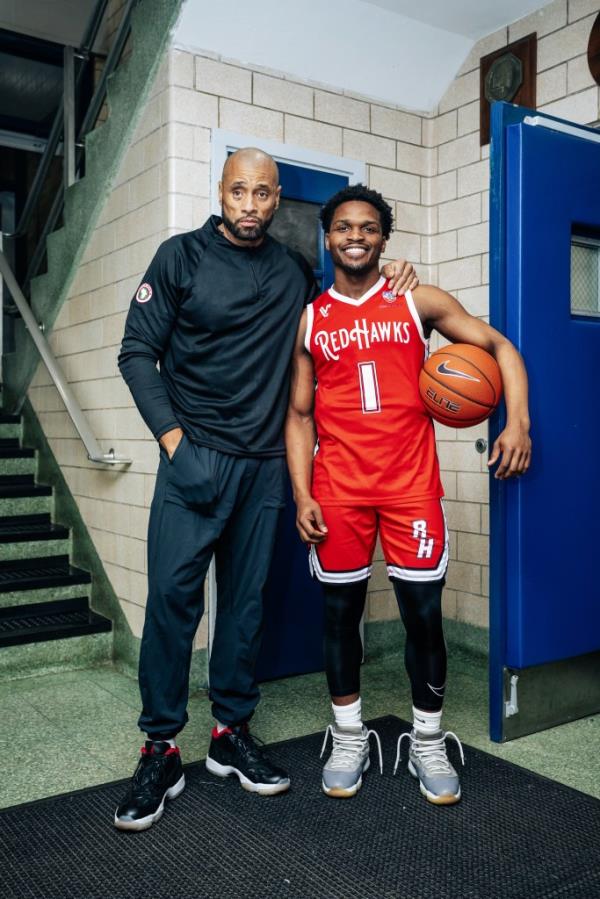 Coach Jarrett Lockhart and guard Arthur Dukes in locker room
