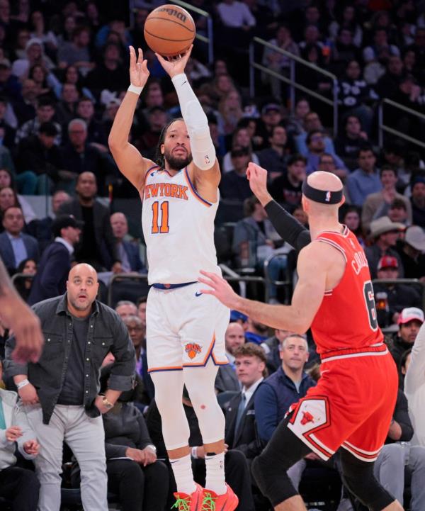 Knicks guard Jalen Brunson #11 hits a three point shot over Chicago Bulls guard Alex Caruso
