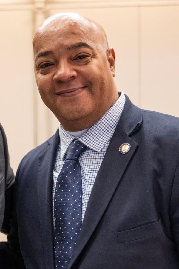 Assembly member Edward Gibbs in a suit and tie attending the 47th Annual Three Kings breakfast celebration in El Museo del Barrio, New York
