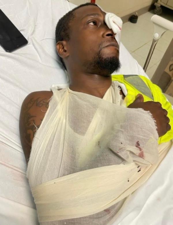 Subway cleaner Anthony Nelson bandaged in a hospital bed.