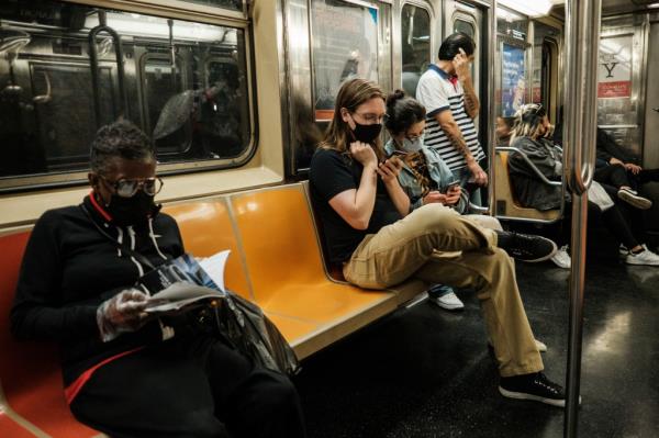 New Yorkers ride the subway after dark as post vaccination life comes back after the outbreak of covid-19. 