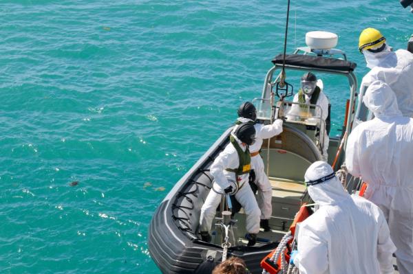 sailors from HMAS Brisbane prepare to board a rigid-Hulled inflatable boat to co<em></em>nduct search and rescue operations in the vicinity of Lindeman Island, Australia on Saturday, July 29, 2023, as part of a multi-natio<em></em>nal and multi-agency search and rescue effort following an Australian Army MRH-90 Taipan helicopter ditching in waters near the island.