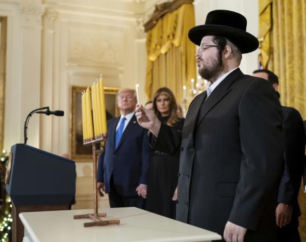 Then-President Do<em></em>nald Trump attends a candle-lighting ceremony in December 2019.