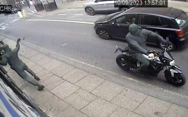 CCTV of the attack on Clo<em></em>nezone sex shop in Manchester on Sunday afternoon, September 10, 2023. Release date ? September 11, 2023. See SWNS story SWMRattack. A sex shop with the UK?s ?largest selection of dildos? has been attacked by balaclava-clad thugs on a motorbike for the FIFTH time in just four months. Clonezone, a 'beloved and ico<em></em>nic queer sex shop' in the heart of Manchester's gay village, was vandalised by two masked men on Sunday afternoon. The shop, which boasts the UK's largest selection of top quality gay sex toys on its website, has now been targeted on five different occasions. Police probing the attacks have released CCTV footage of two masked men, dressed all in black, approaching the shop on a bike. One of the thugs gets off the bike and attempts to smash the windows - which are now protected by iron bars following previous attacks on the store. When this fails, he then throws an object at the doors and also at the security equipment which was placed on the outside the premises. The latest incident has caused around ?3,500 worth of damage and comes four mo<em></em>nths after a similar attack caused ?4,000 worth of damage. Cops have made an arrest after the latest attack, but have appealed for information in a bid to to locate the bike used in the long-running campaign of damage.