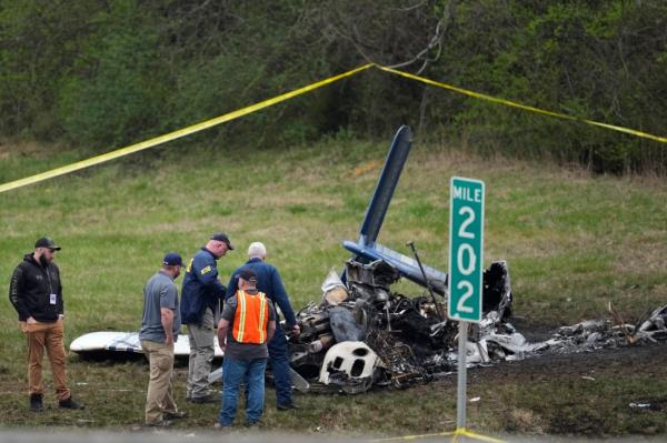 Investigators look around the debris field of the single-engine plane near mile marker 202 on Interstate 40 on March 5, 2024.