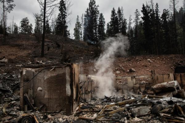 Remains of a home smouldering due to wildfires in Jasper, Alta., causing evacuation of the natio<em></em>nal park on July 26, 2024