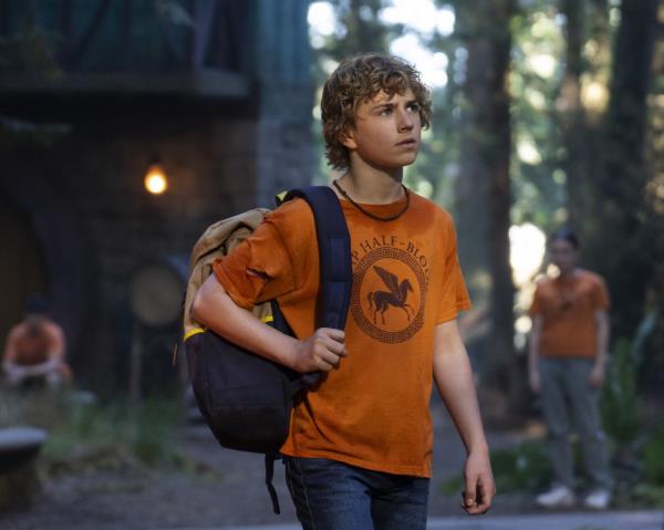 Walker Scobell holding a backpack. 
