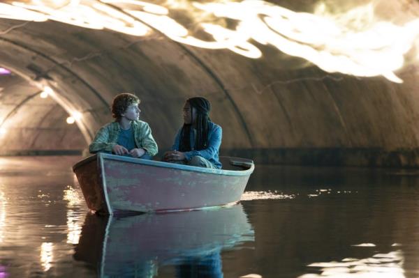 Walker Scobell and Leah Jeffries sitting in a boat. 