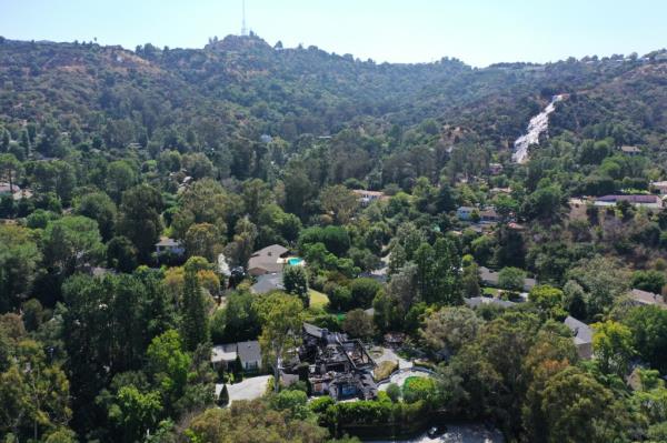 Aerial view of the remnants of Cara Delevingne's home in Los Angeles, surrounded by trees, taken on September 12, 2024