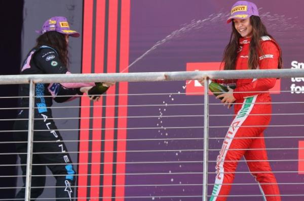 Marta Garcia, right, celebrates on the podium 