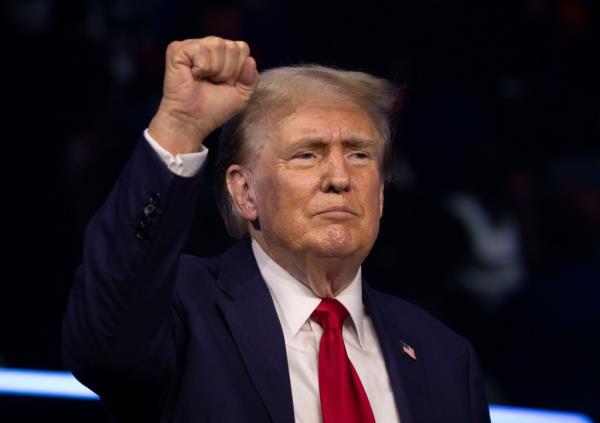 Former President Do<em></em>nald Trump walks on to the stage to give the keynote address at Turning Point Action's 