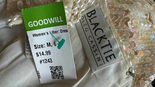 Texas woman, Kansas Michalke, holding a gown she discovered at Goodwill, designed by Jackie Kennedy's perso<em></em>nal dressmaker.
