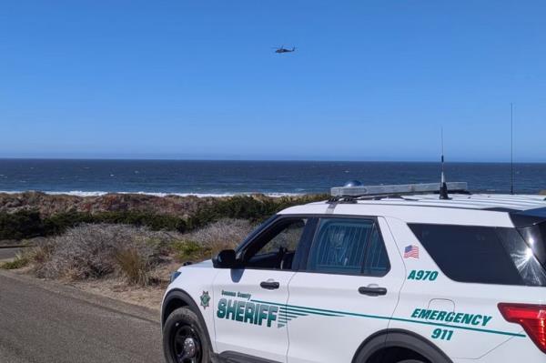 Sheriff's police cruiser near beach.