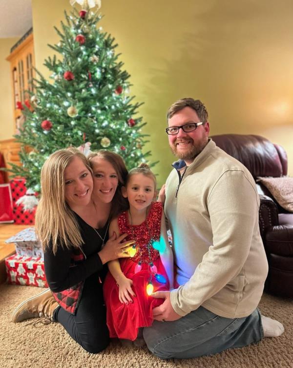 The twins and Josh with a child. 