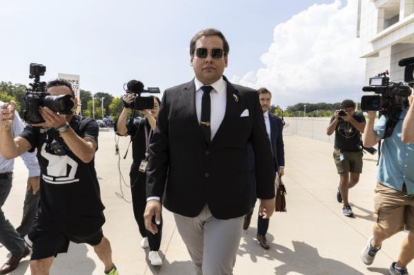 Former US Representative George Santos arrives at court in Central Islip, NY.