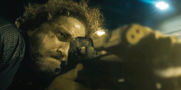 Gerard Butler fires a gun as Big Nick in Den of Thieves 2 Pantera